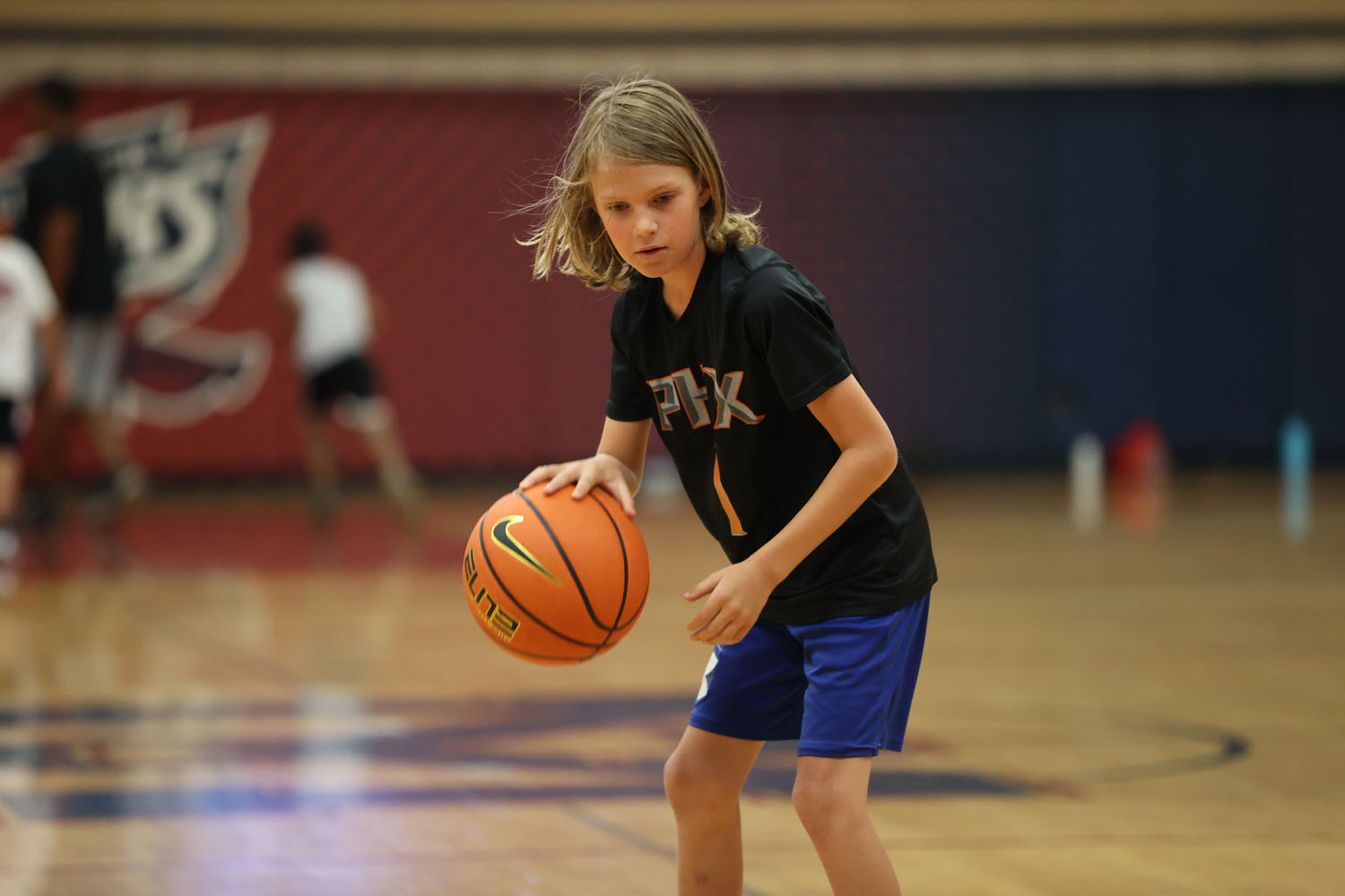 Young camper dribbling the ball