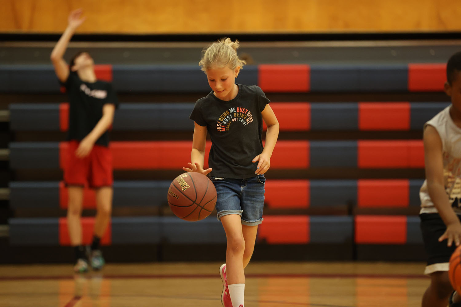 Young camper dribbling down the court